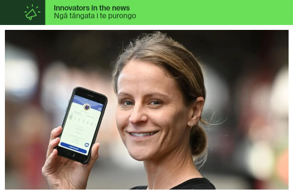 Founder of Elli Cares, the dementia care app, Angela Edwards, holding a phone showing the app